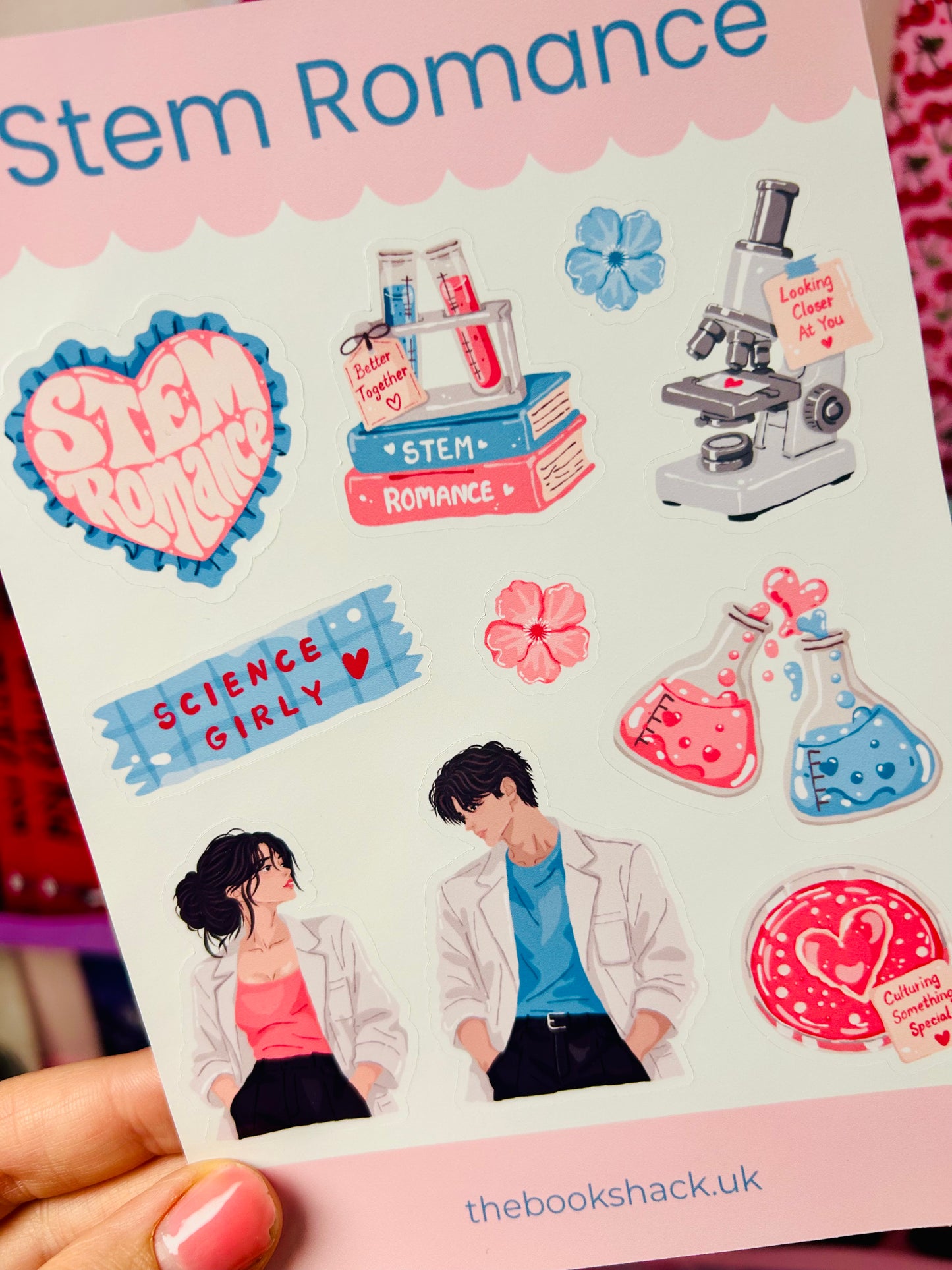 Romance sticker sheet close-up with hearts, microscope, beakers, and scientist couple in lab coats