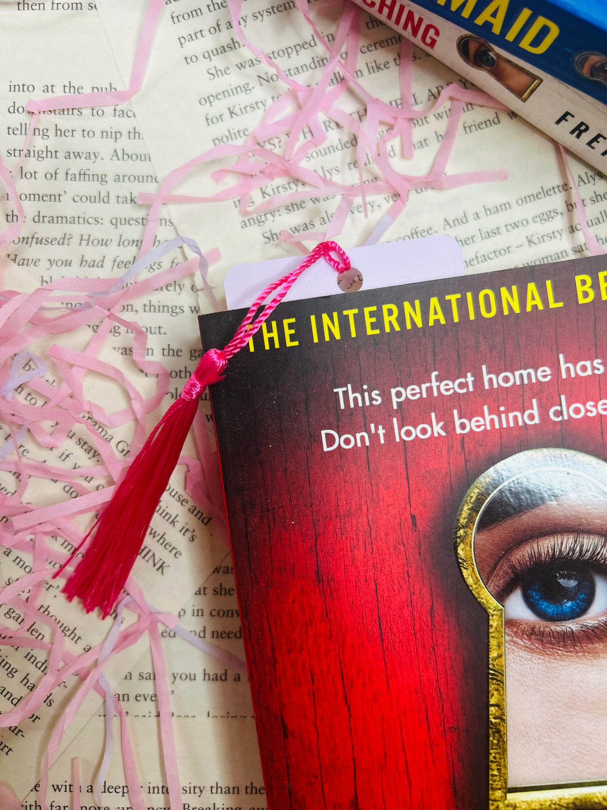 Book bookmark with white card, pink tassel, and bold 'THRILL ME BABY ONE MORE TIME' text