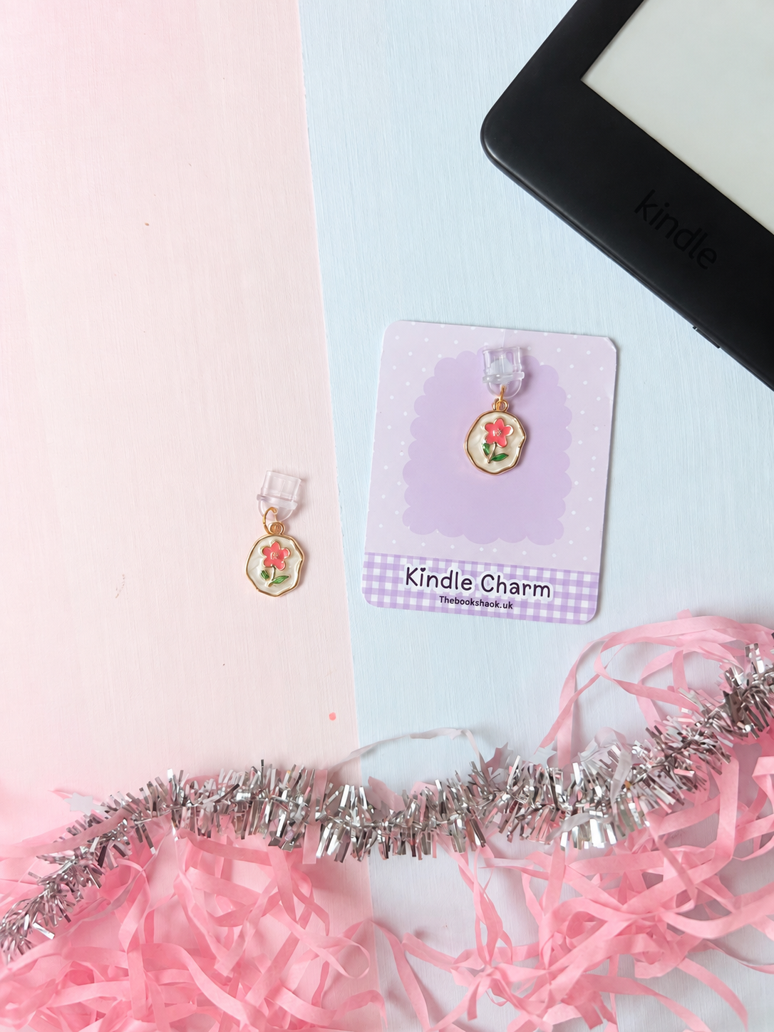 Kindle USB-C dust plug charm with pink flower on scalloped card backing