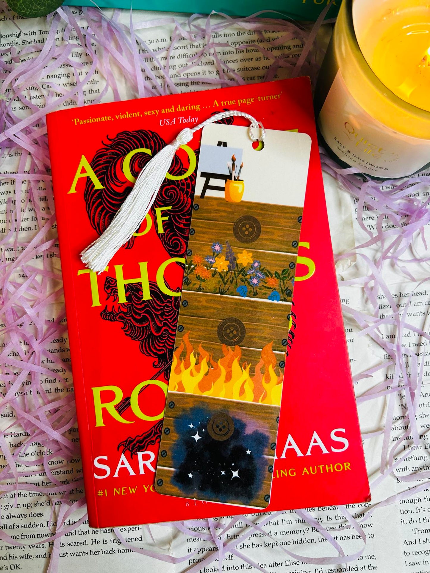 Bookmark featuring Feyre’s drawers-inspired design from ACOTAR, symbolizing art, growth, and character development. Bookmark sat on the first novel of the A court of thorns and roses book series.