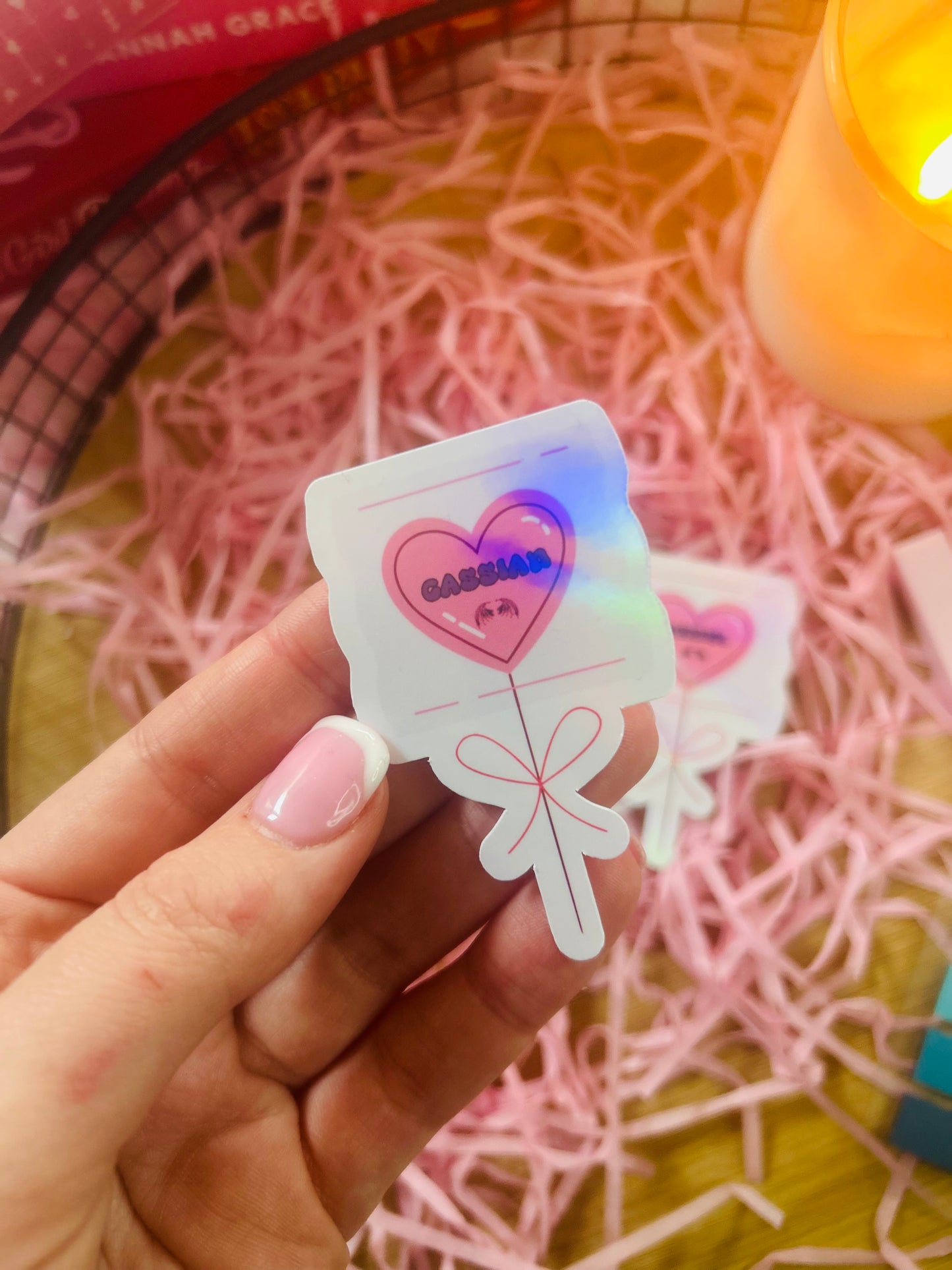 Holographic ACOTAR candy heart balloon stickers featuring Rhysand, Cassian, and Azriel. Perfect bookish merch for fantasy lovers, ideal for decorating laptops, water bottles, and journals.