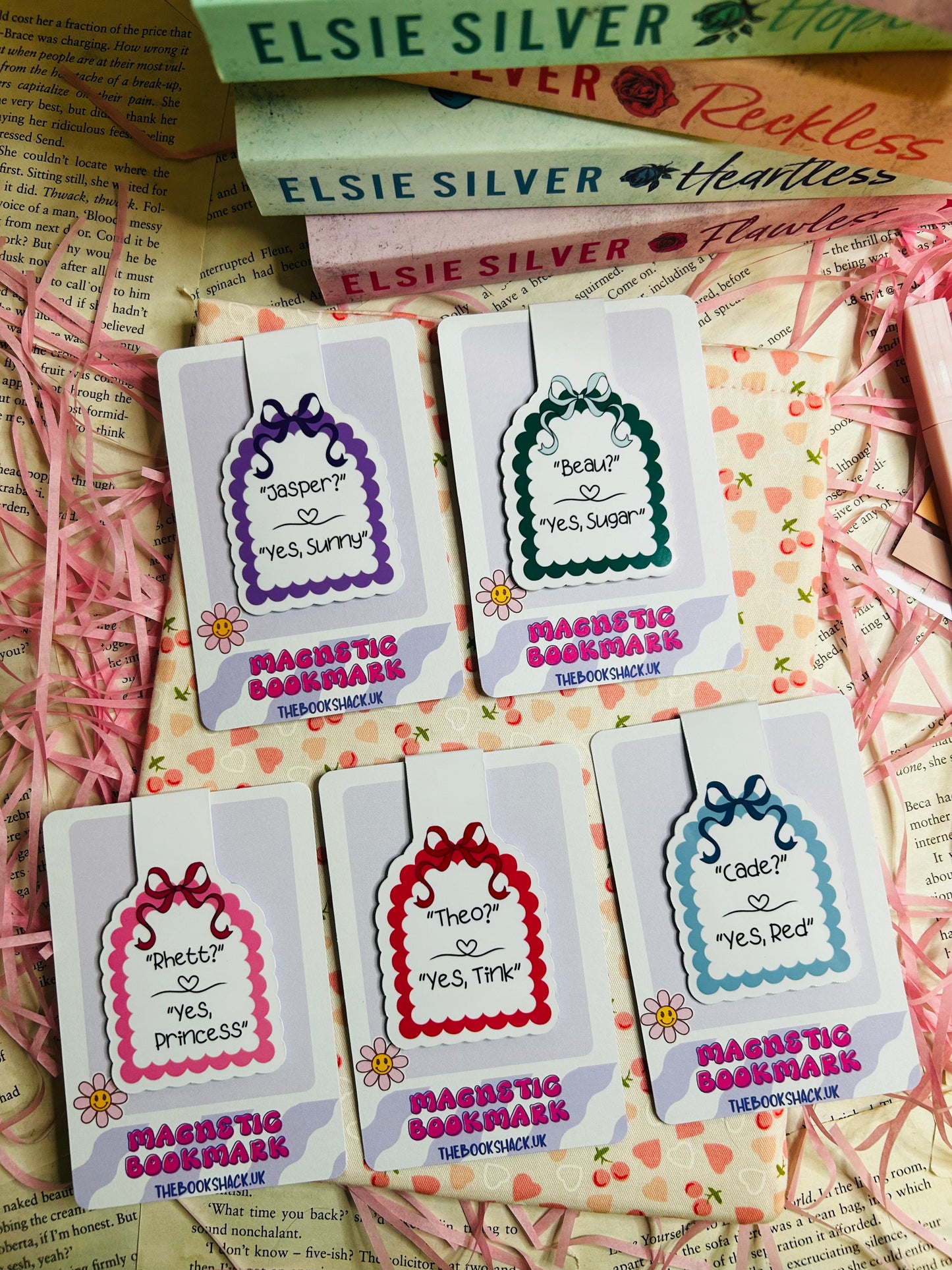 Collection of magnetic bookmarks featuring romantic quotes and character names like 'Jasper,' 'Beau,' 'Rhett,' 'Theo,' and 'Cade' on pastel designs with scalloped edges and bow accents.