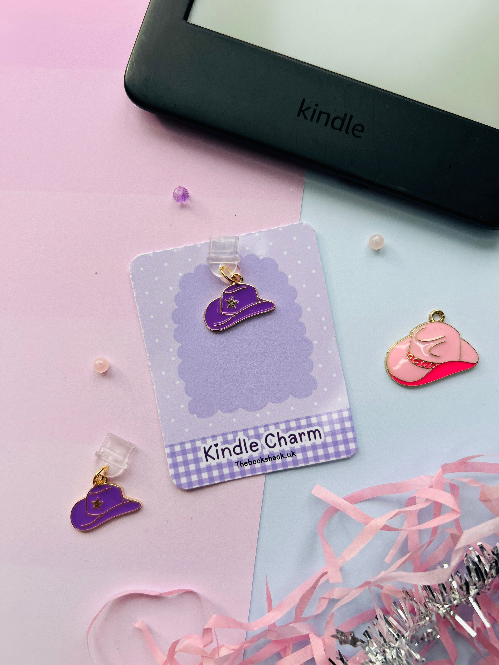 Purple cowboy hat Kindle charm attached to a clear plastic Type-C dust plug, displayed with backing card and holographic packaging, with optional white letter charm.