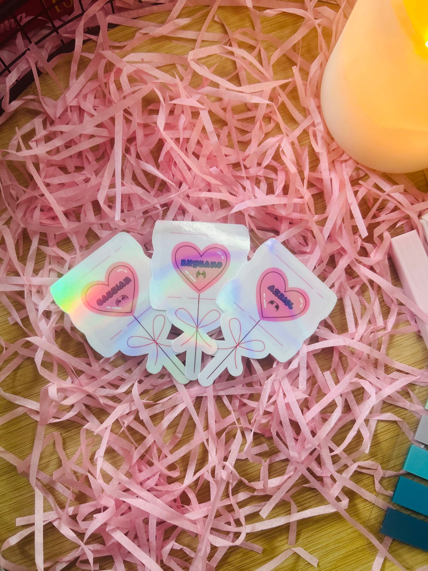 Holographic ACOTAR candy heart balloon stickers featuring Rhysand, Cassian, and Azriel. Perfect bookish merch for fantasy lovers, ideal for decorating laptops, water bottles, and journals.
