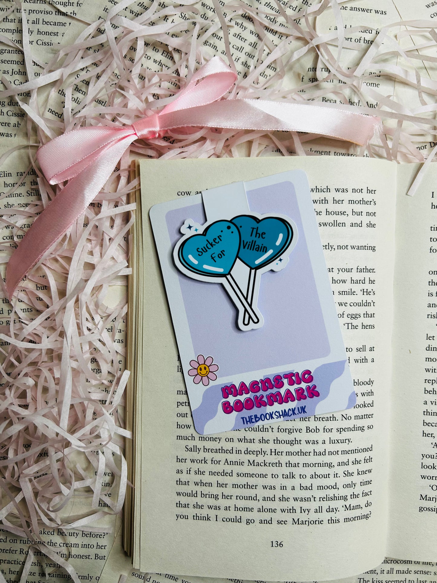 "Magnetic bookmark showcasing two striking blue heart-shaped balloons with the captivating phrase 'Sucker for The Villain.'