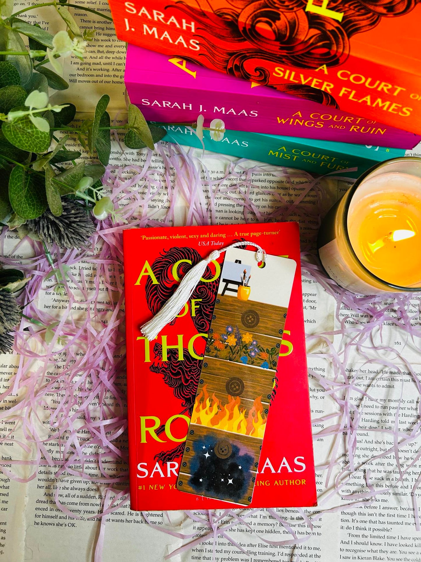 Bookmark featuring Feyre’s drawers-inspired design from ACOTAR, symbolizing art, growth, and character development. Bookmark sat on the first novel of the A court of thorns and roses book series.