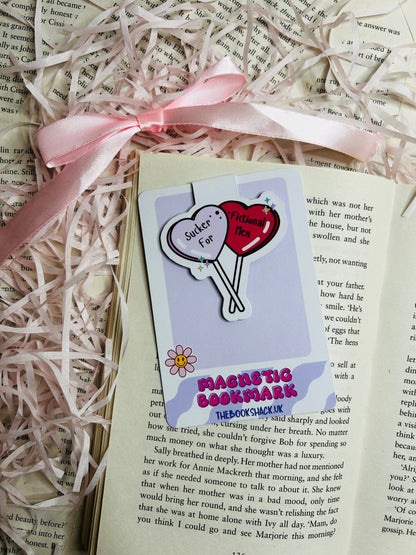 Magnetic bookmark with a playful design featuring two heart-shaped balloons reading 'Sucker for Fictional Men.