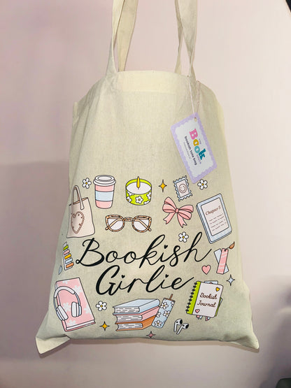 Cotton tote bag with 'Bookish Girlie' graphic, hanging tag, books and stationery icons