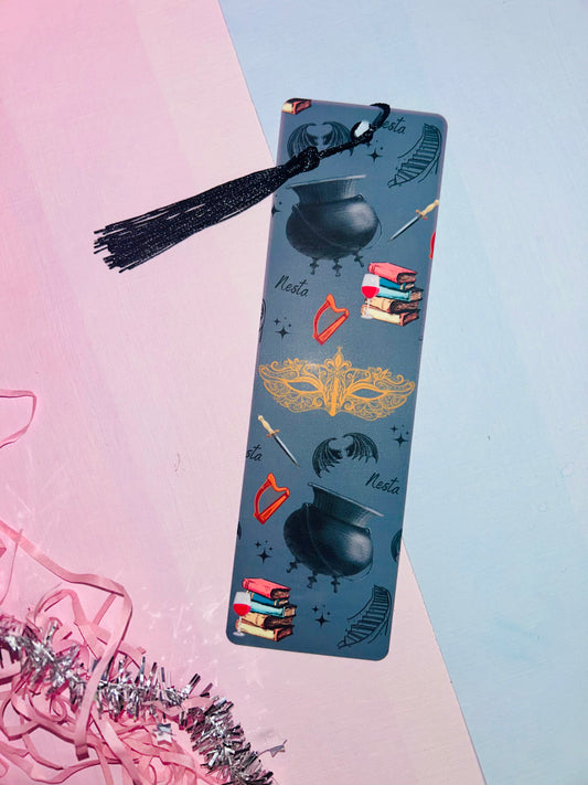 Blue illustrated bookmark with black tassel, star-and-knife motifs
