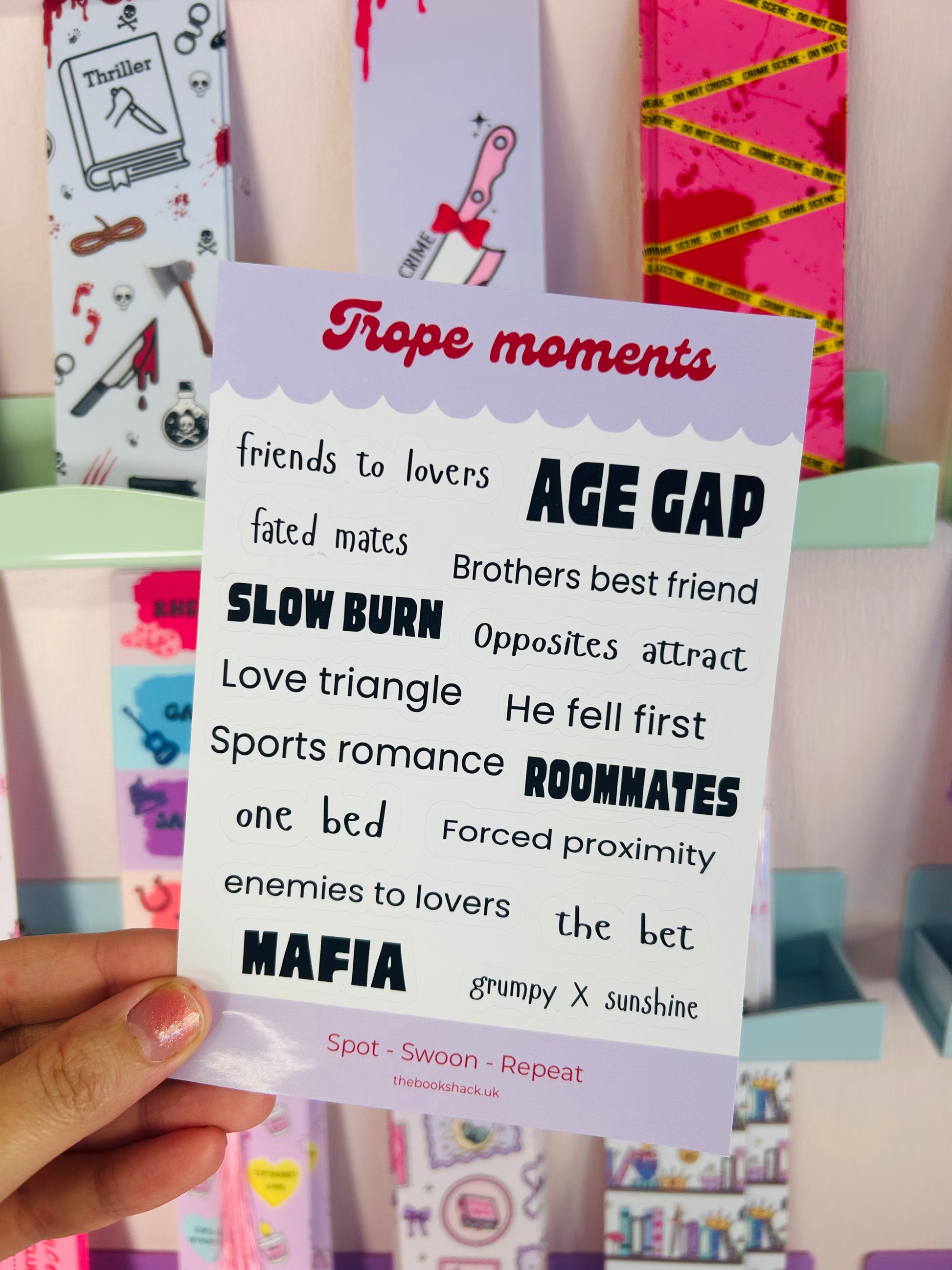 Handheld trope moments sticker sheet, purple title card with multiple book trope phrases