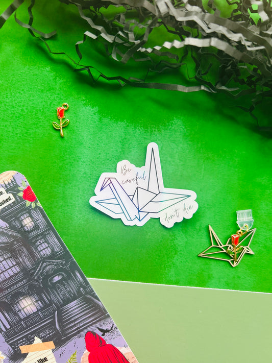 Alchemised/dramione crane ‘be careful don’t die’ Inspired Holographic Sticker – Fantasy Bookish Laptop & Kindle Decal