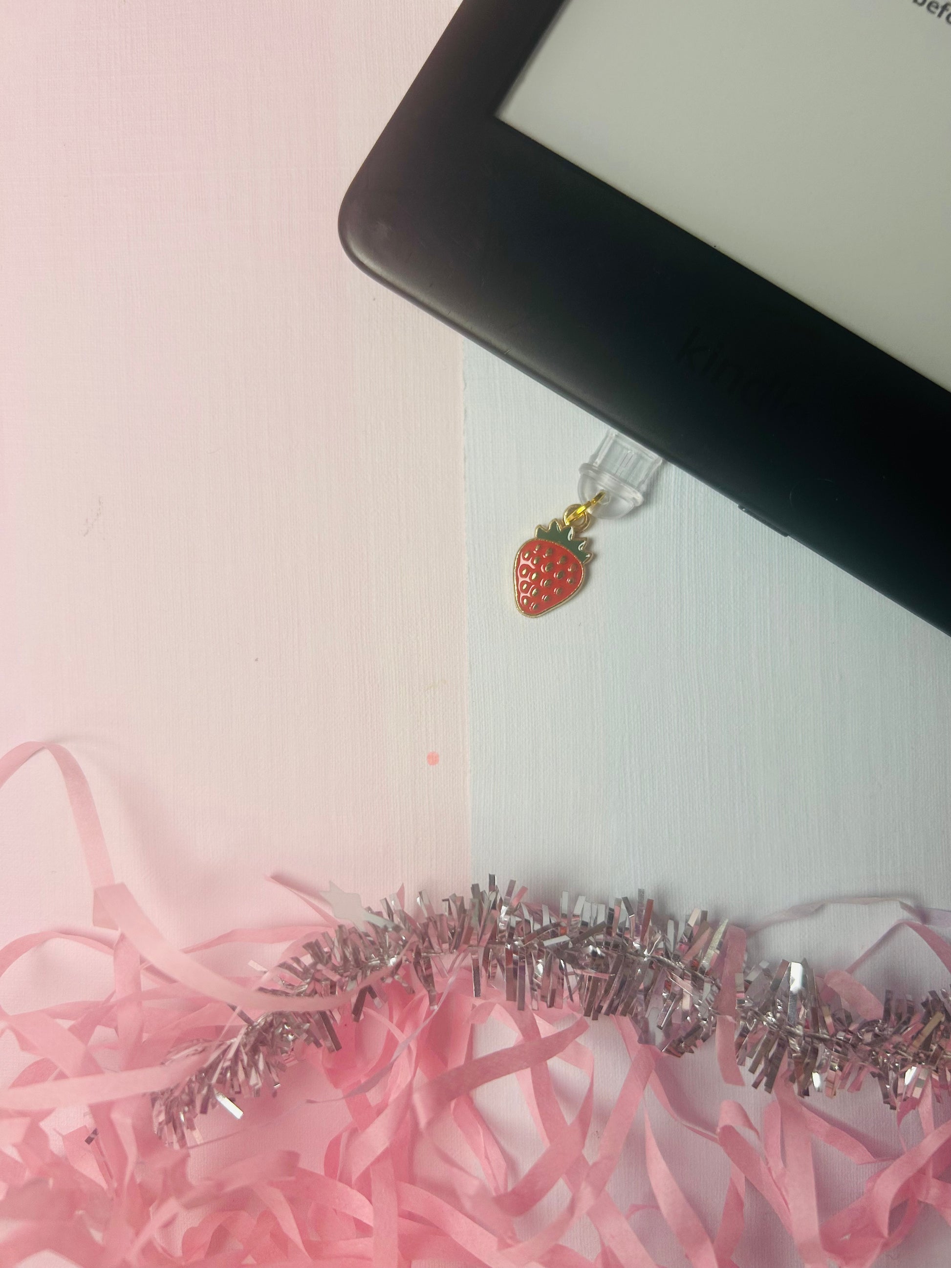 USB-C dust plug charm with gold loop and strawberry enamel pendant