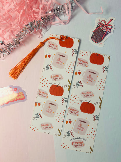Set of autumn pumpkin spice paper bookmarks with orange tassels and coffee cup pattern