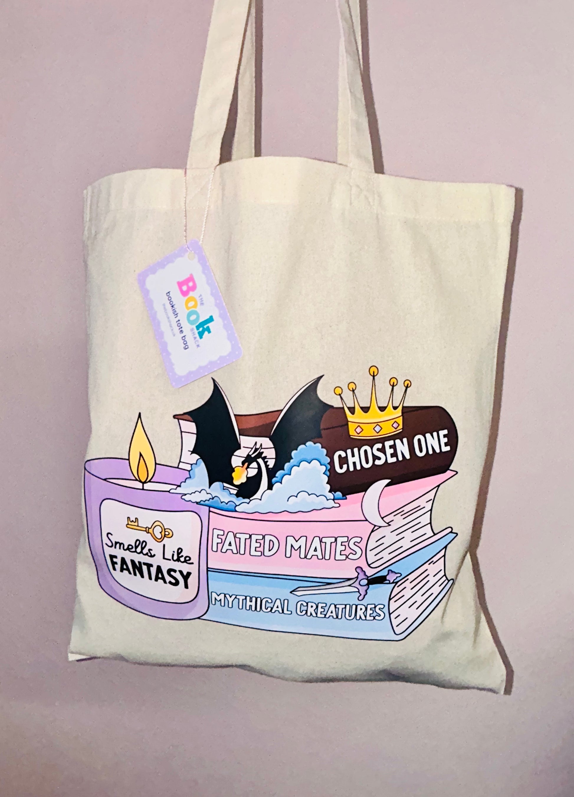 Cream canvas tote bag with front print: chosen one fantasy book stack and dragon.