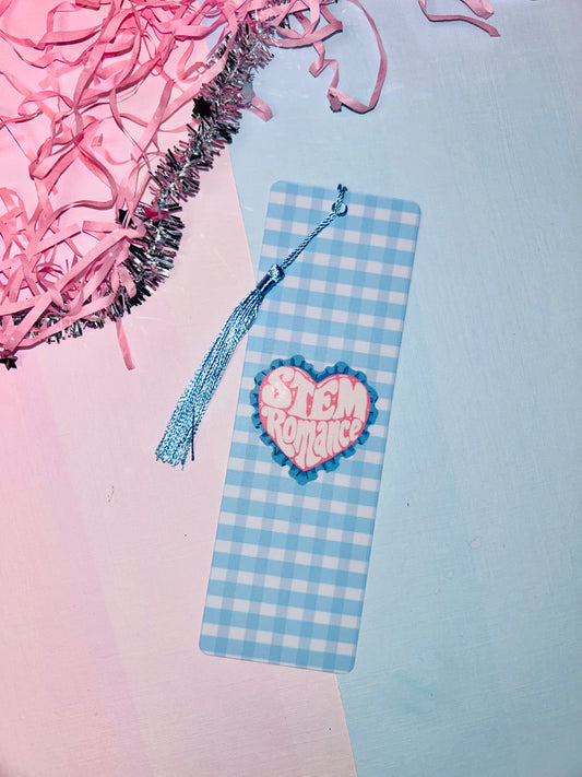Double-sided science romance bookmark: blue check cover, pink heart badge, blue tassel