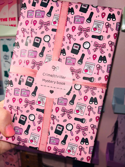 Pink crime/thriller mystery book with patterned accessory icons