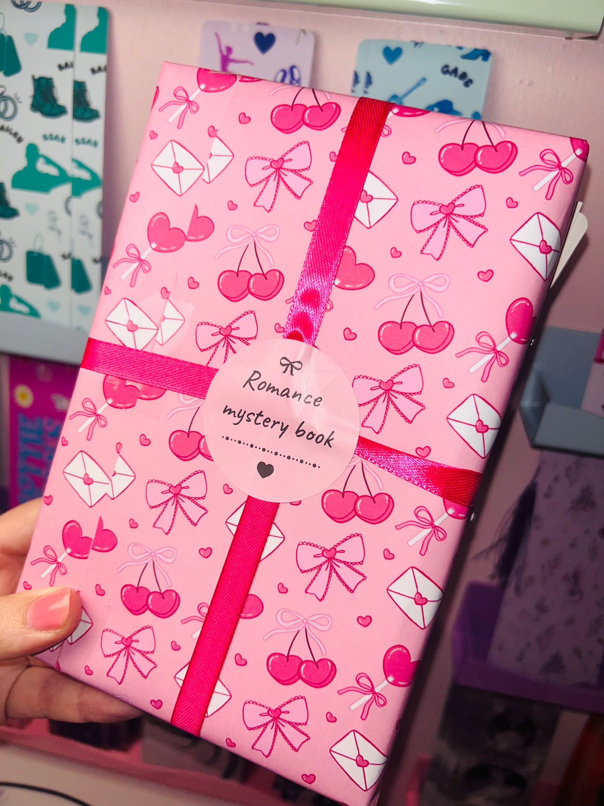 Pink romance mystery book with hearts and bows pattern and pink ribbon tie
