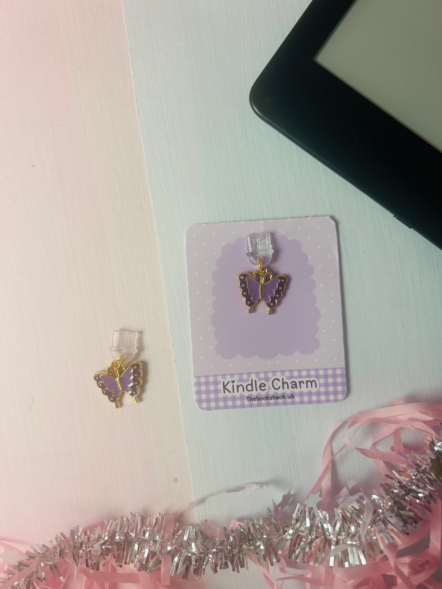 Purple butterfly Kindle charm on card with 'Kindle Charm' label and gold-tone details