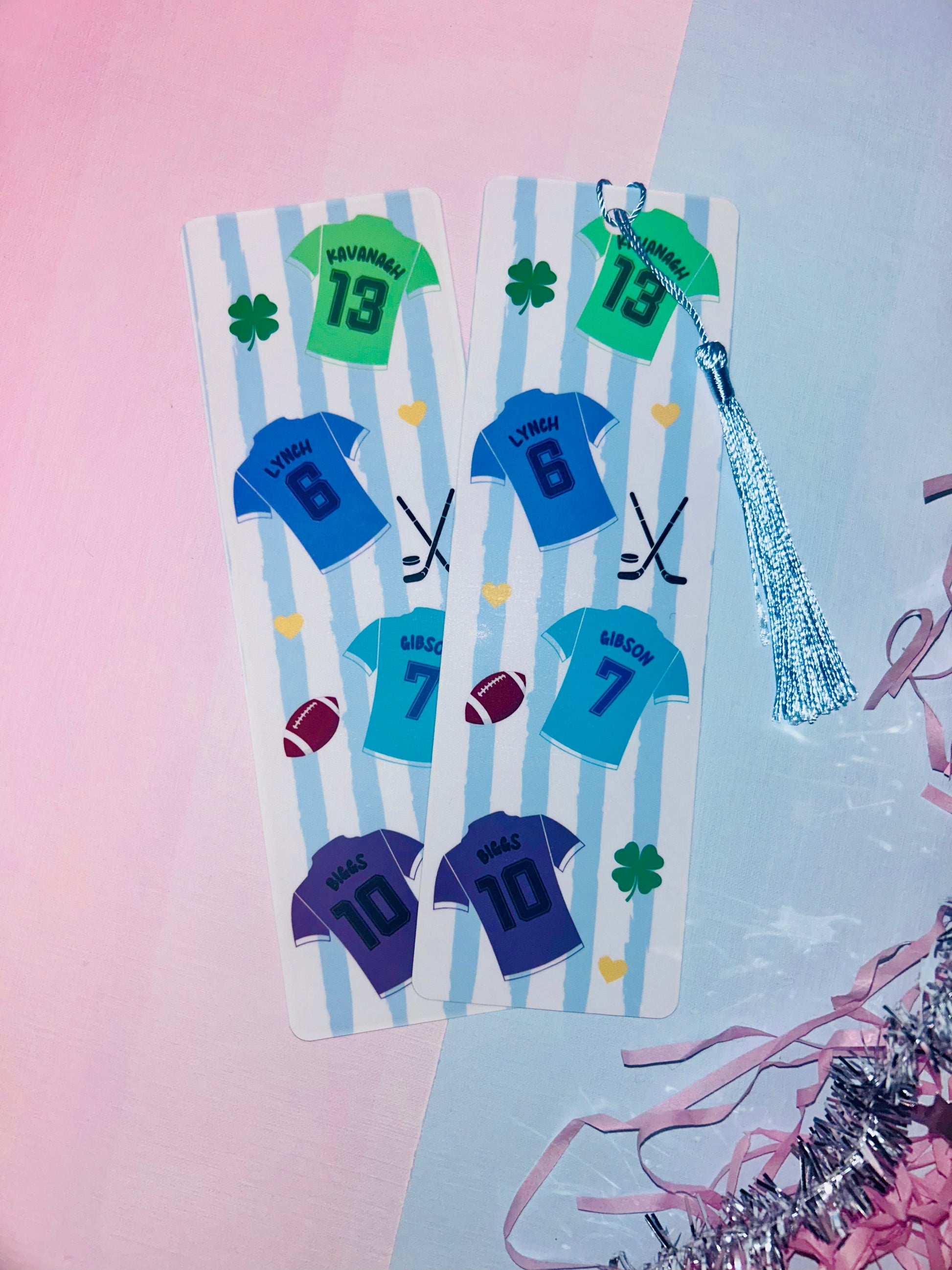Fabric bookmark pair with blue jersey-style numbers, green 13 patch, and silver tassel