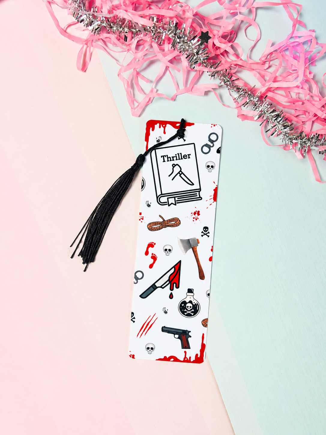 Crime-themed paper bookmark with black tassel, white card covered in red and black icons