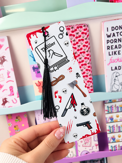 White crime bookmark with black tassel, illustrated with red blood, guns, and skulls