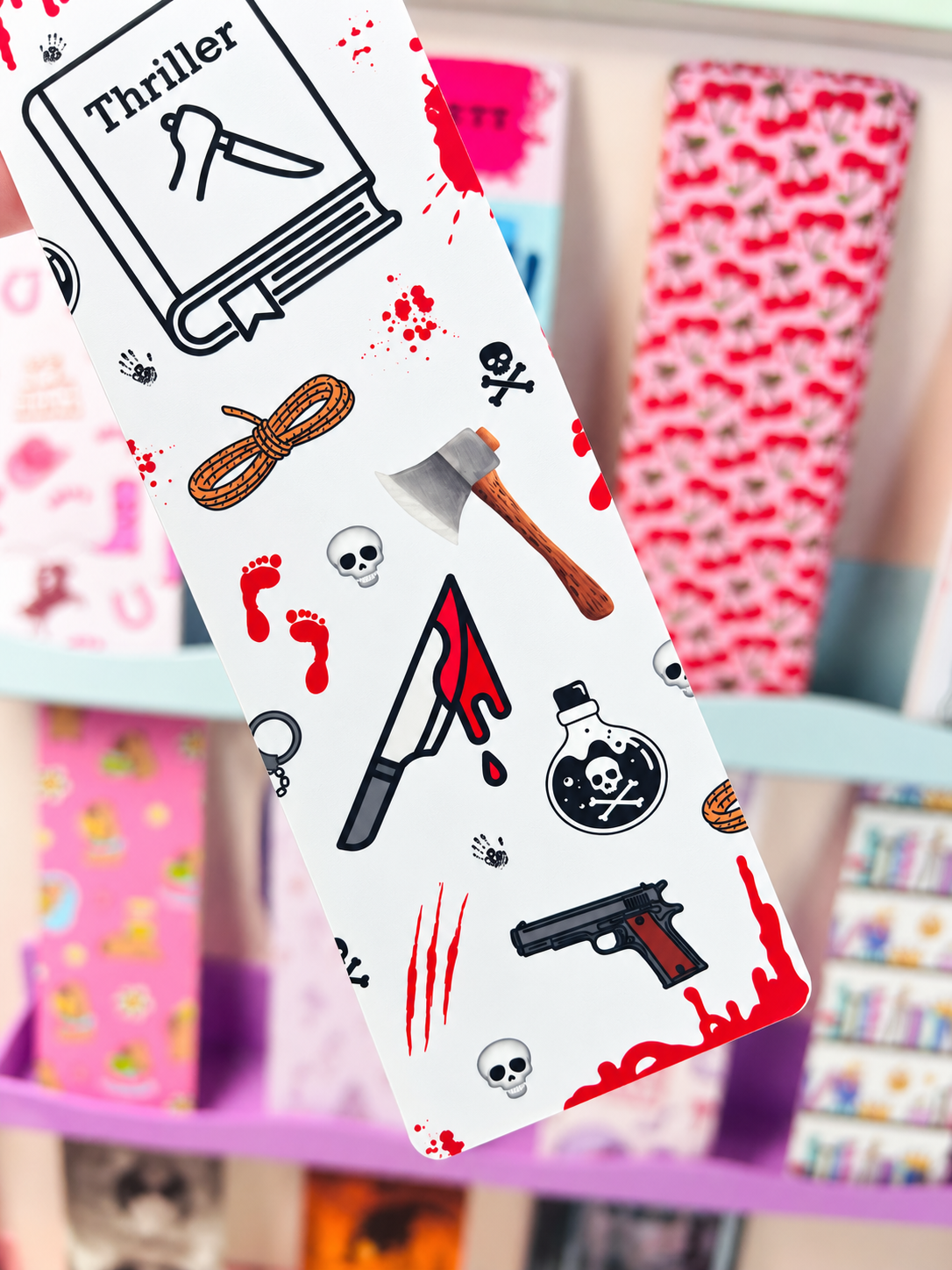 Crime bookmark close-up, white card with red splatter, skulls, gun and ax icons
