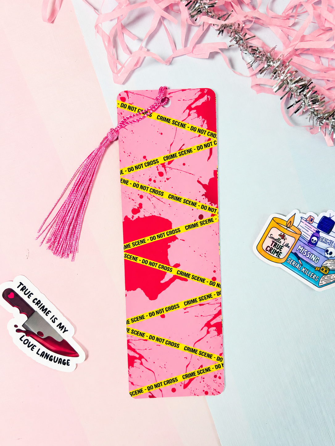 Pink bookmark with neon crime scene tape lines and long pink tassel