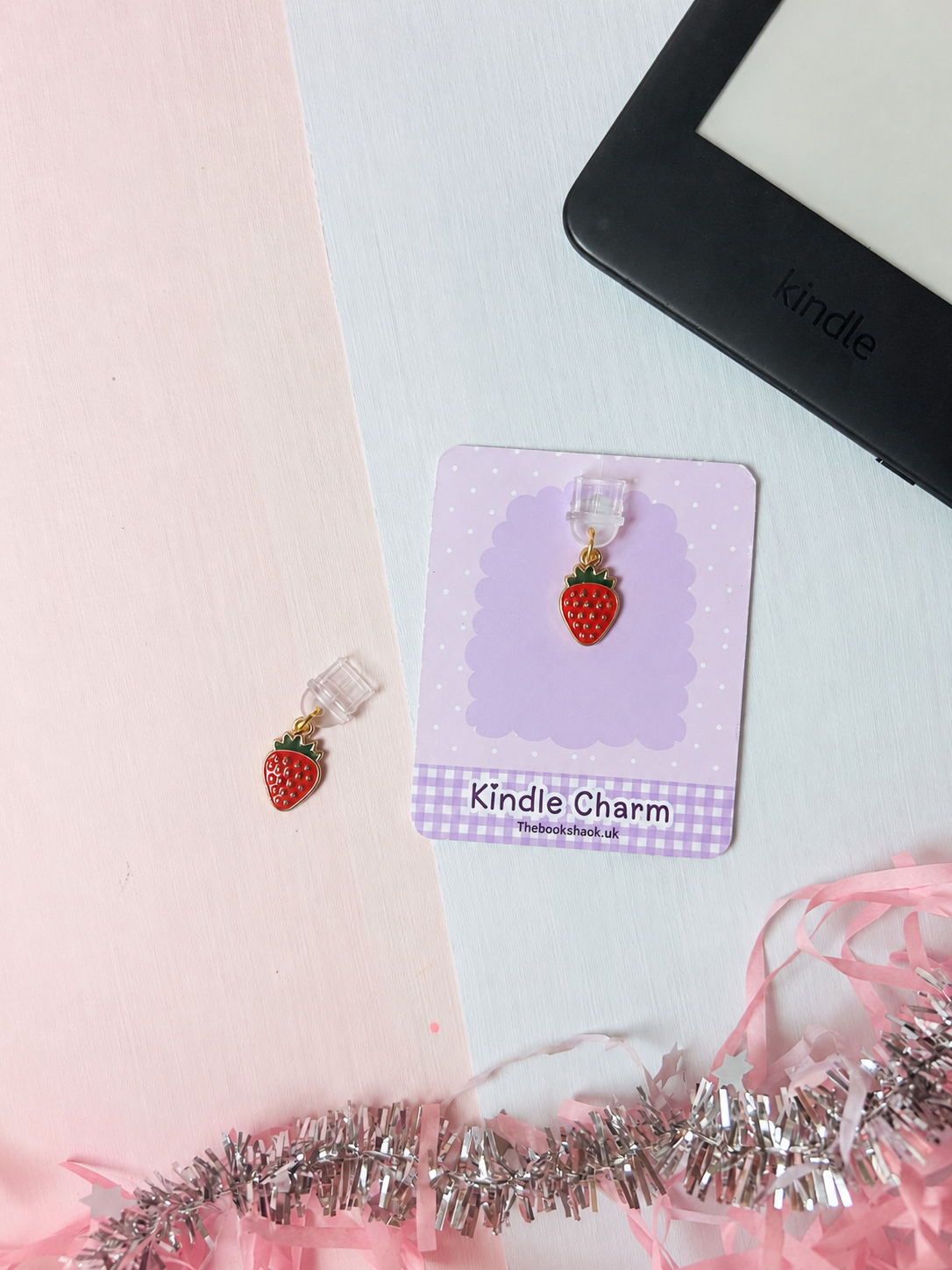 Strawberry USB-C dust plug charm shown on purple card with clear connector