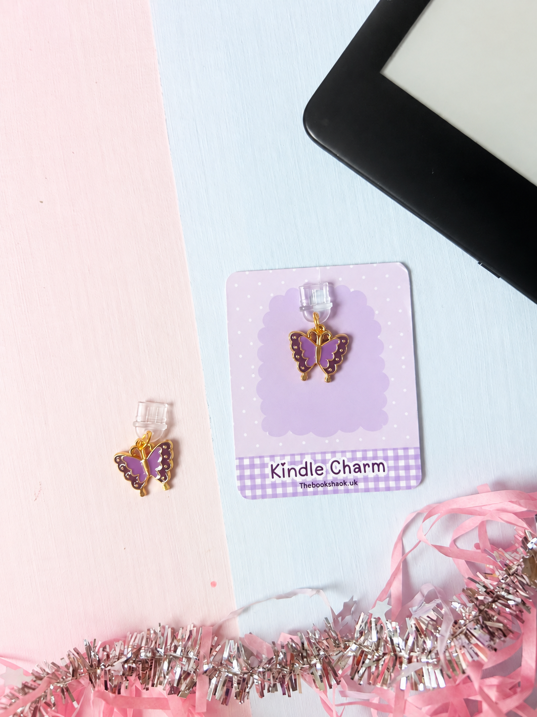 Purple butterfly USB-C dust plug charm on lavender backing card with scalloped edges