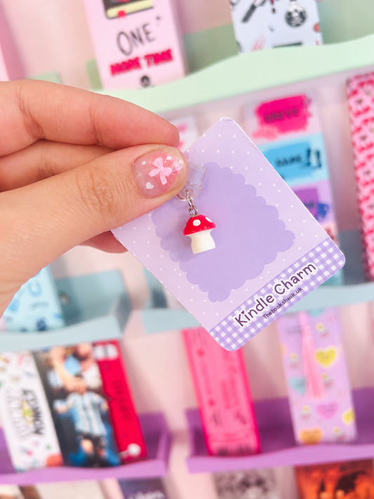 Toadstool mushroom Kindle charm held on purple card, red cap with clear dust plug