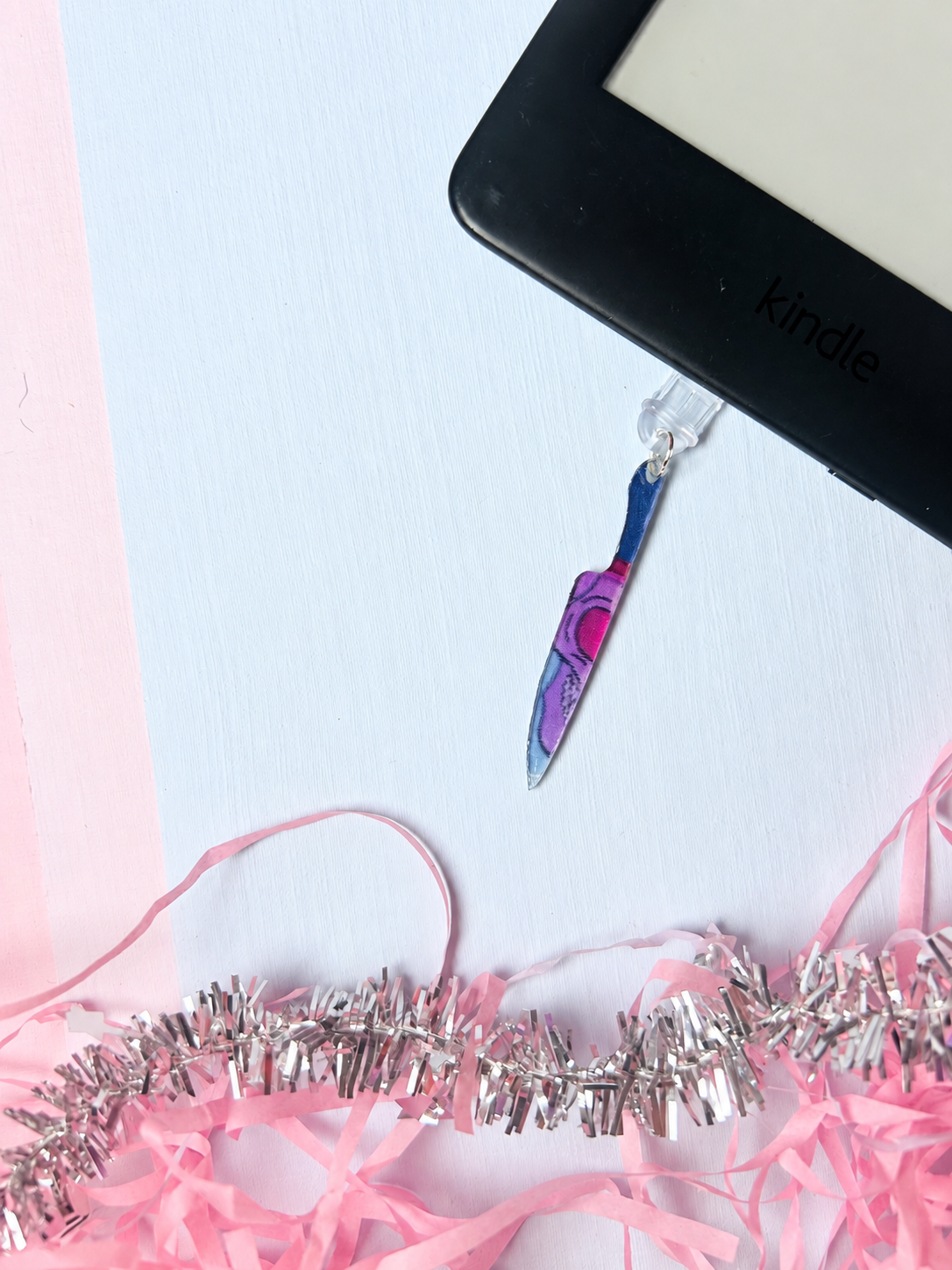 Purple knife-shaped Kindle dust plug charm with small clear clip