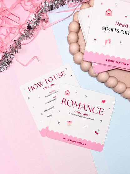 Set of Romance TBR prompt cards held in hand, with red hearts and pink border