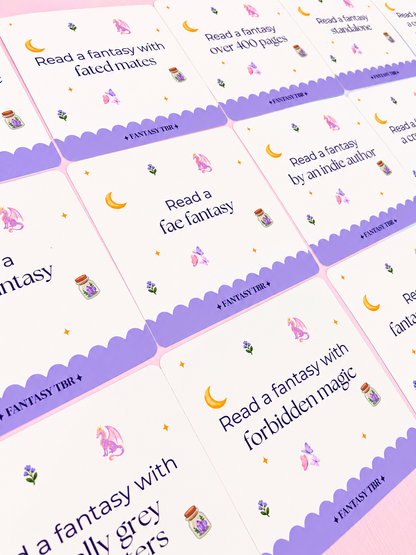 Assorted Fantasy TBR cards spread out with moon, potion, unicorn, and butterfly icons