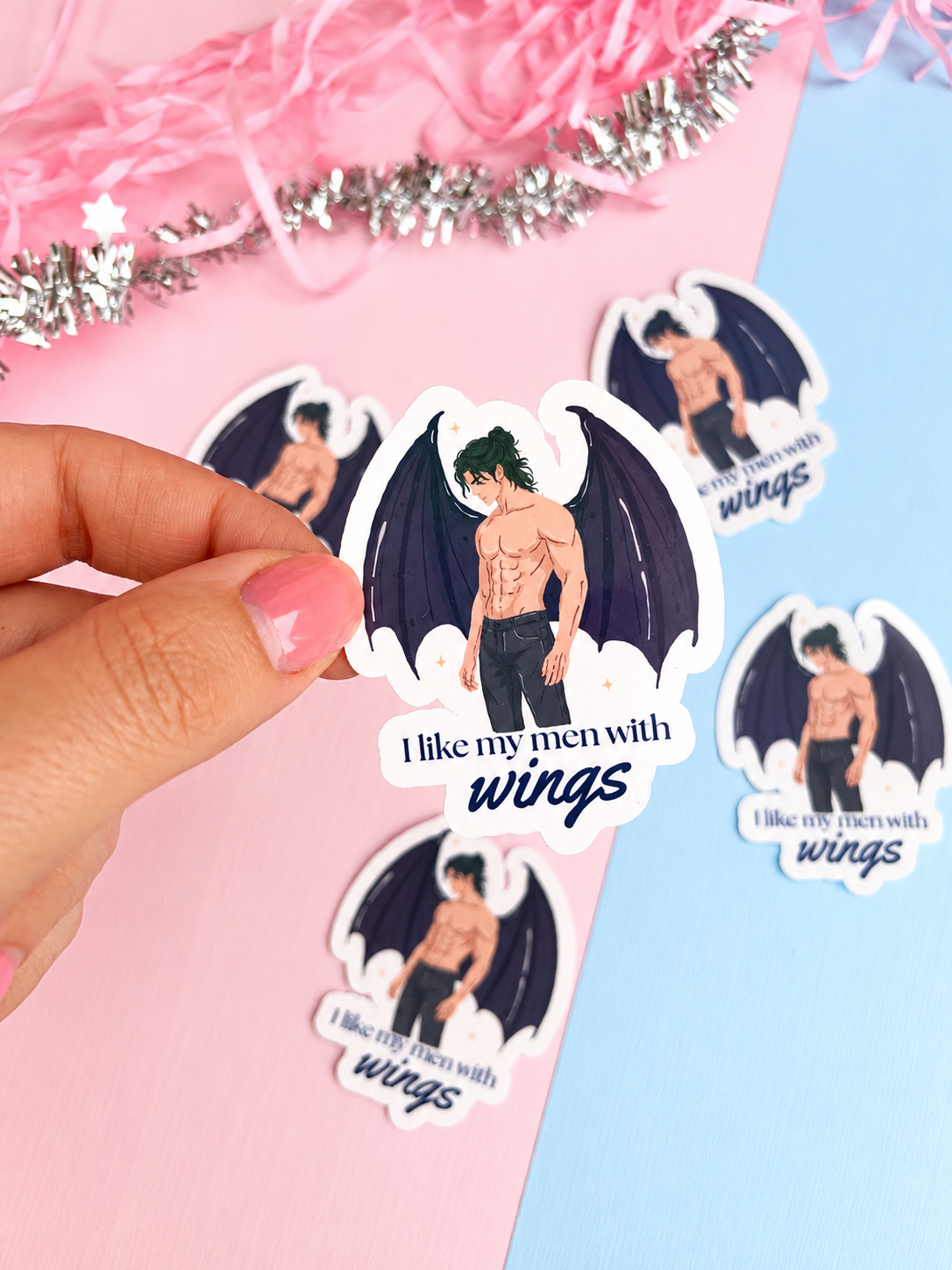 Winged man holographic-style sticker: "I like my men with wings"