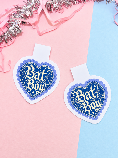 Two heart-shaped blue and white magnetic bookmarks with Bat Boy logo design