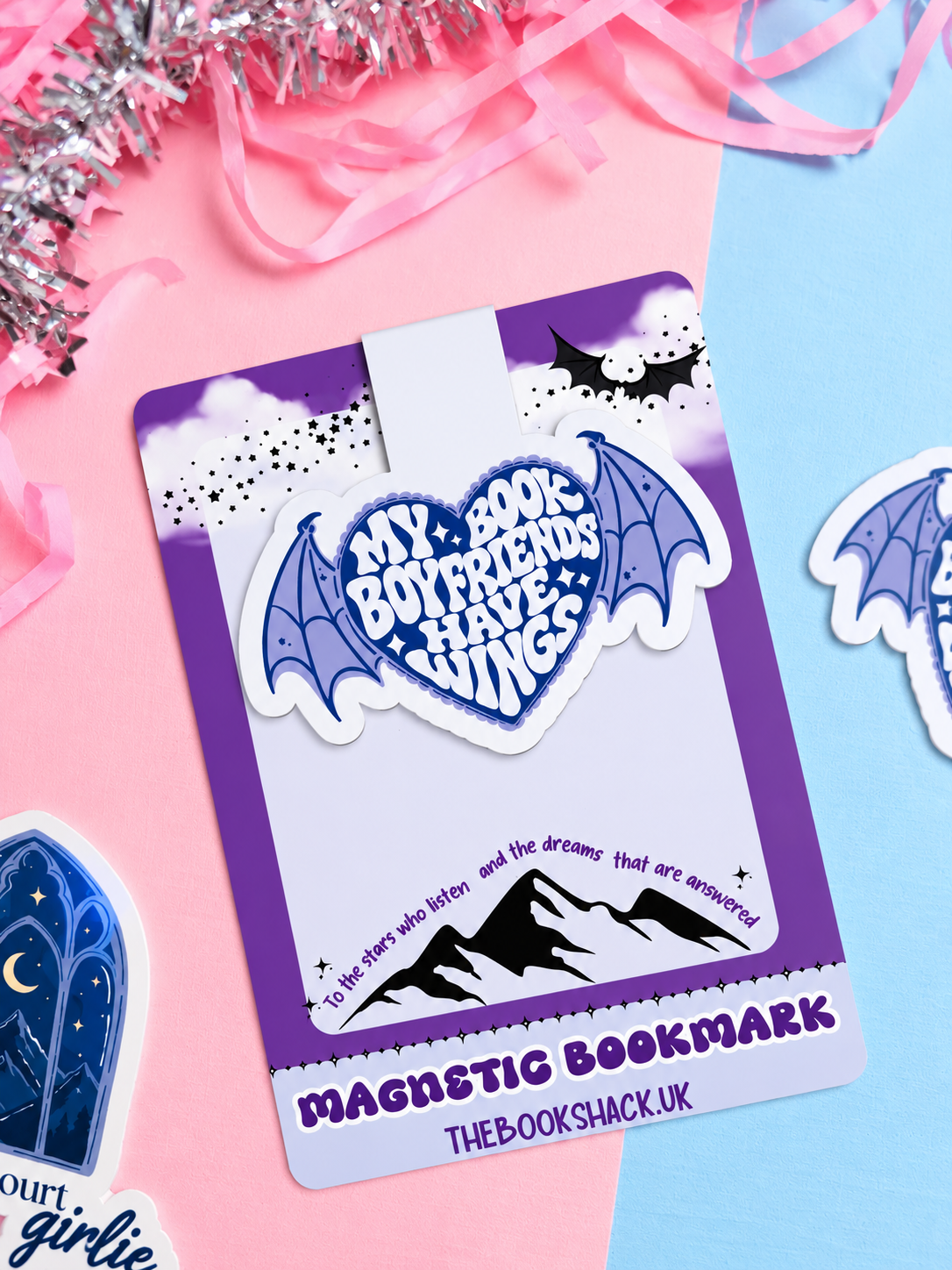 Magnetic bookmark with blue winged heart logo and star details on a card backing.
