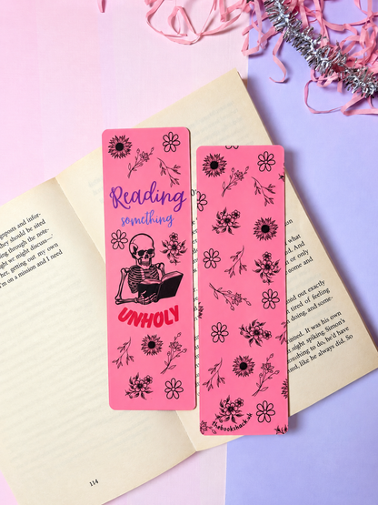 Pink floral bookmark pair; skeleton reading art on left, tassel not visible
