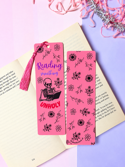 Pink skeleton bookmark with tassel and Reading something, plus floral design
