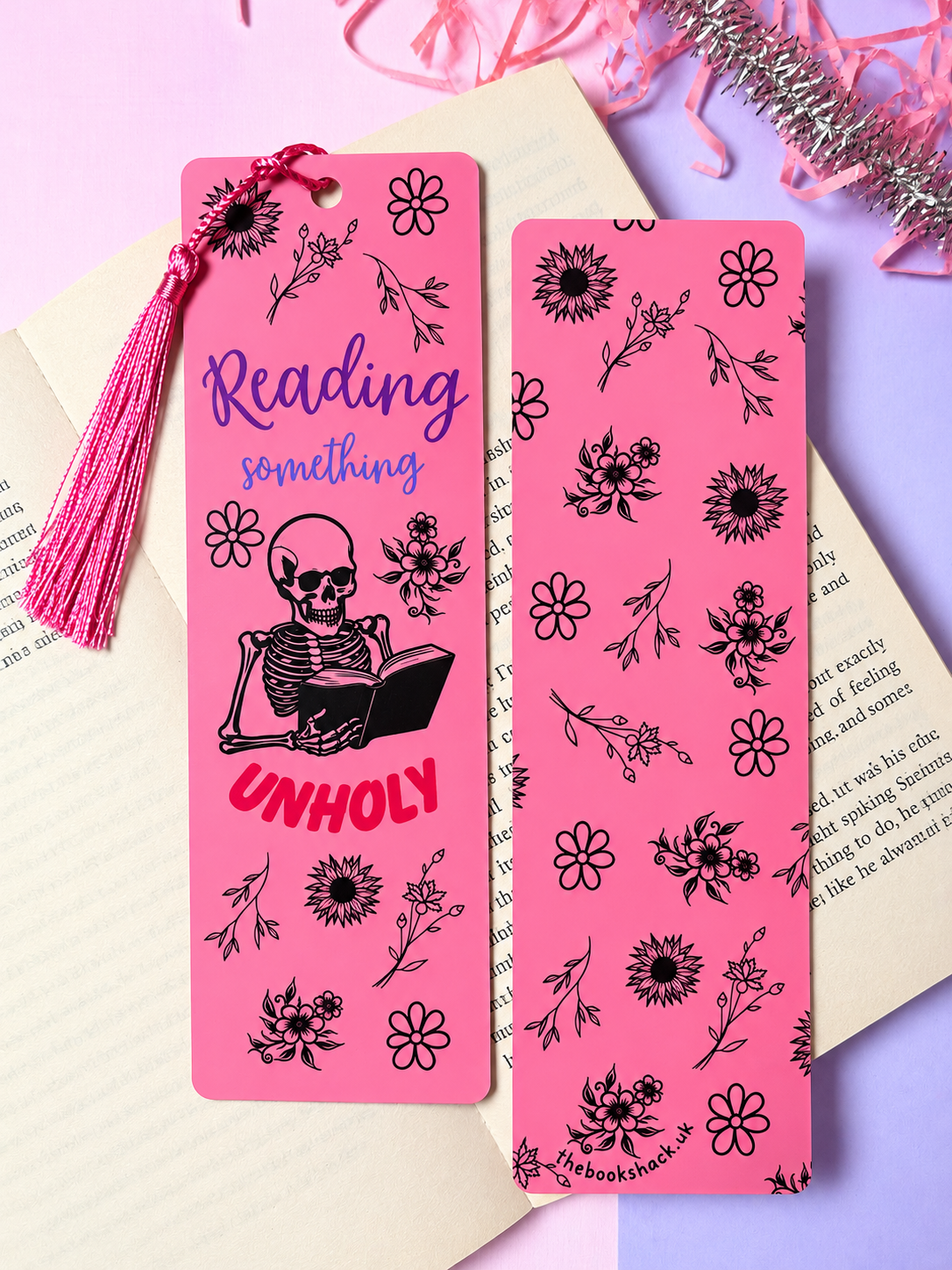 Pink bookmark set with skeleton reading art, floral pattern, and tassel detail