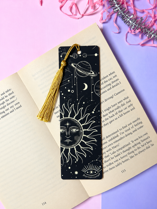 Black celestial bookmark with white sun/planet art and gold tassel
