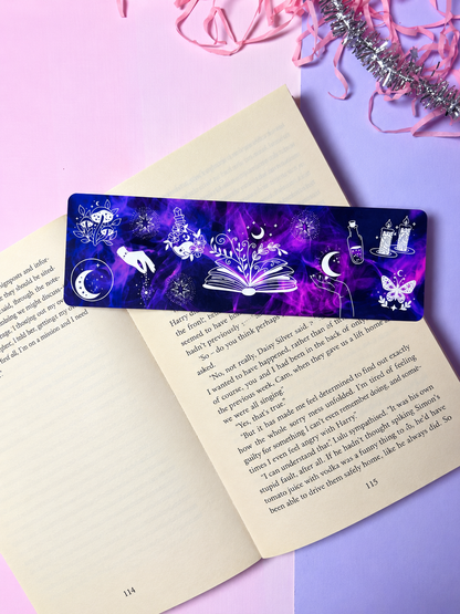 Dark blue and purple celestial bookmark with open book, crescent moons, wand and potion icons