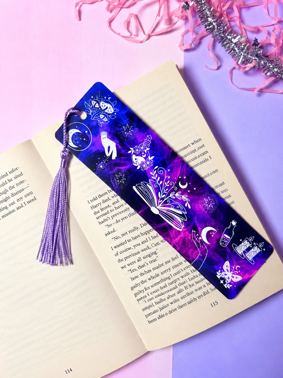 Dark blue and purple celestial bookmark with dangling tassel, ornate moon and star motifs