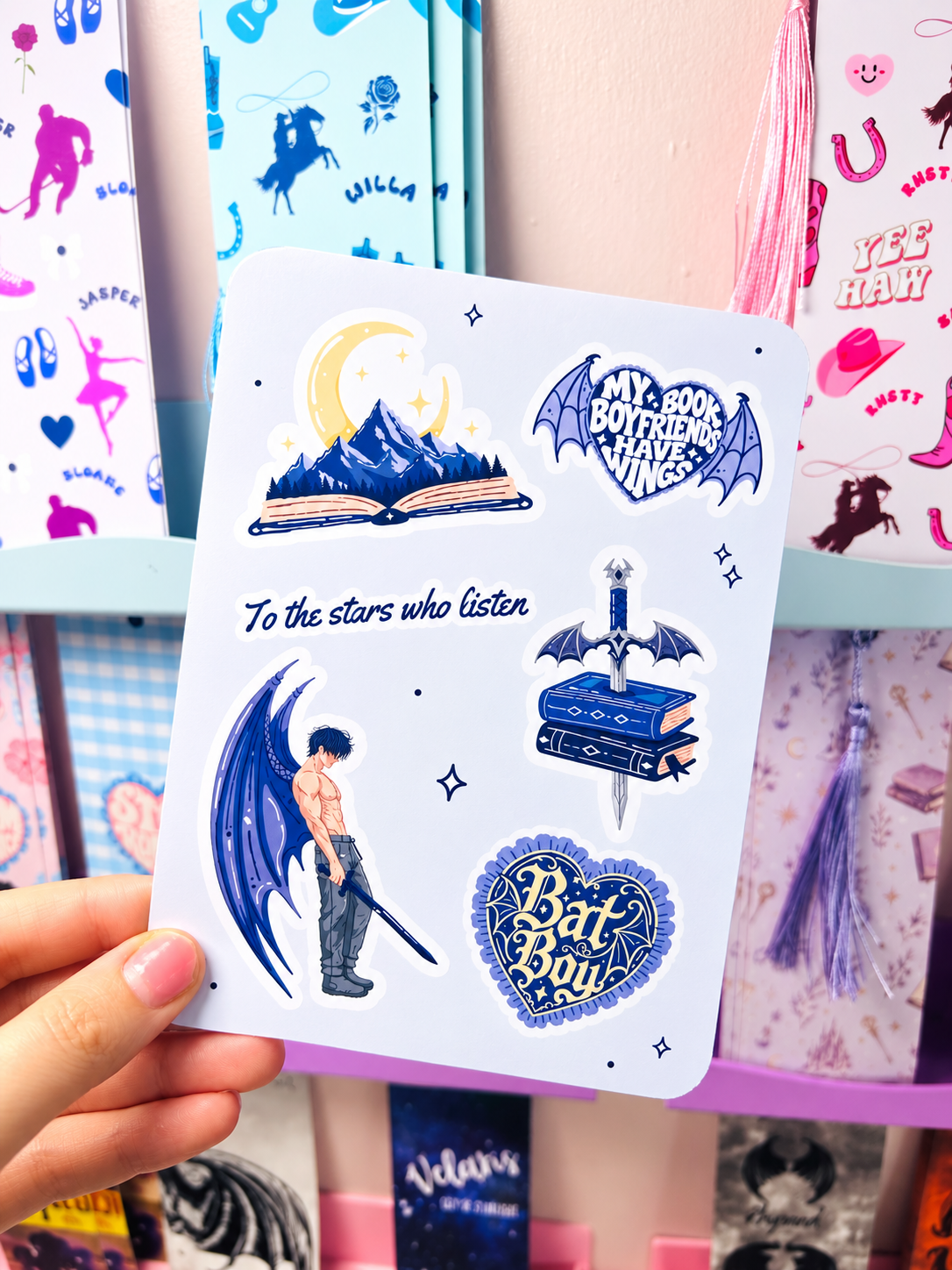White Kindle insert with blue fantasy figures, moon, and heart badge stickers