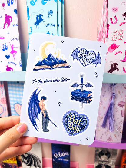 White Kindle insert with blue fantasy figures, moon, and heart badge stickers