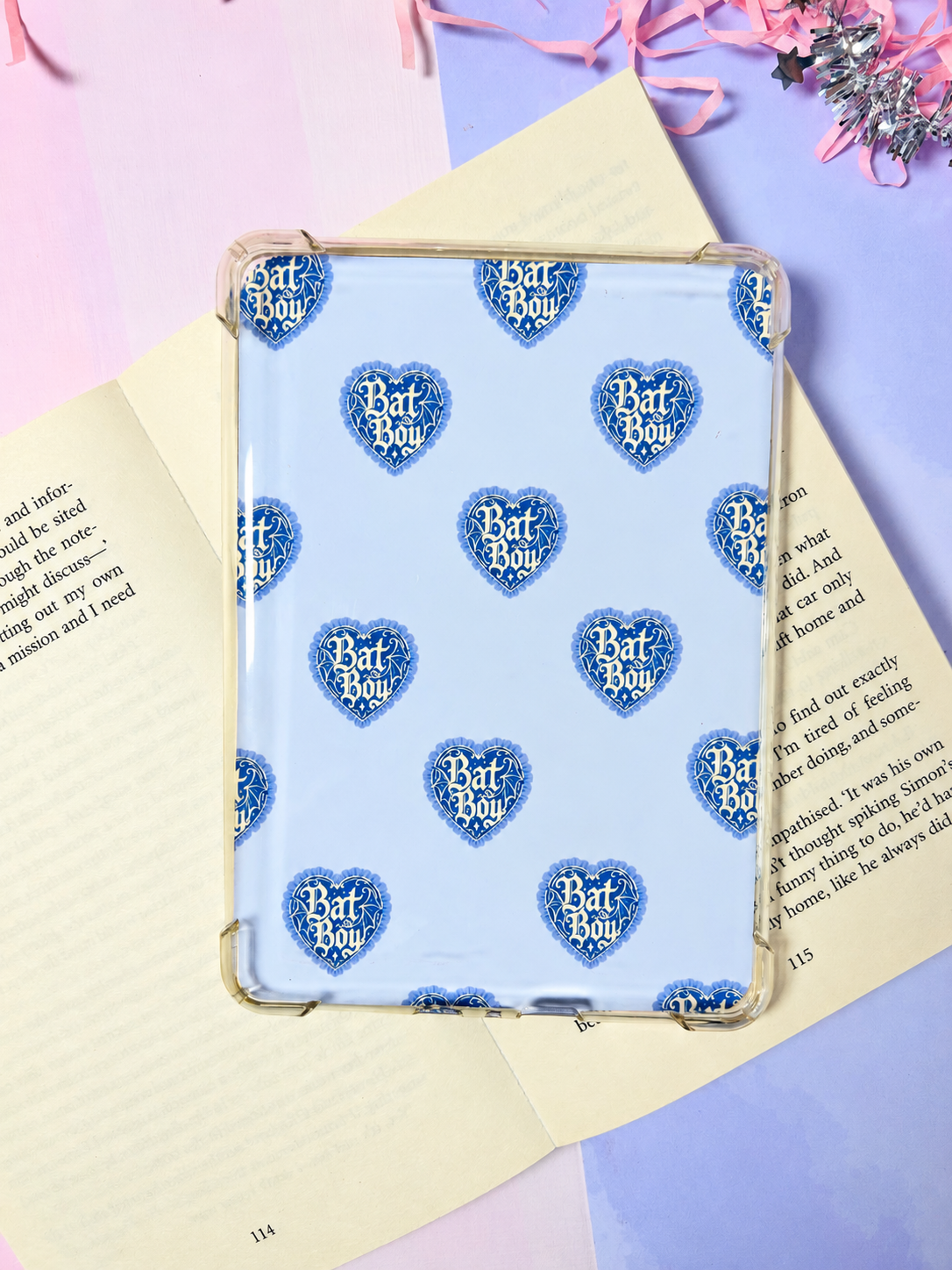 Kindle insert with blue Bat Boy heart pattern in a clear protective frame