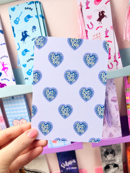 Kindle insert sheet with repeated blue Bat Boy heart logos on a light background