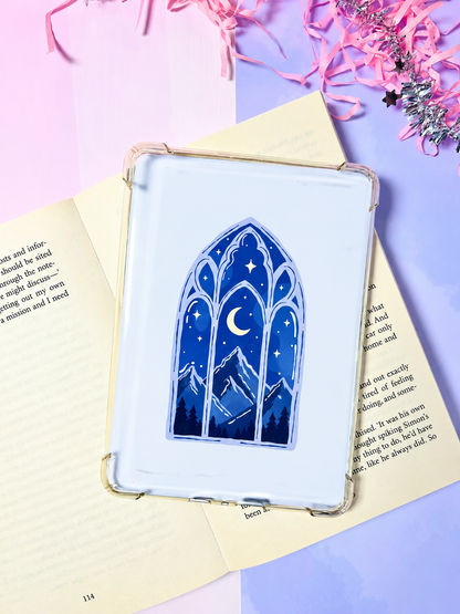 White Kindle insert card in a transparent case with blue arched window and crescent moon.