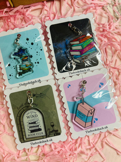 Flat lay of an ACOTAR-themed mystery bookish bundle featuring double-sided bookmarks, holographic stickers, a keyring, art print, annotate tabs, pen and highlighter. Items are displayed with Sarah J. Maas books and pink shredded paper, creating a cosy, fantasy-inspired aesthetic.