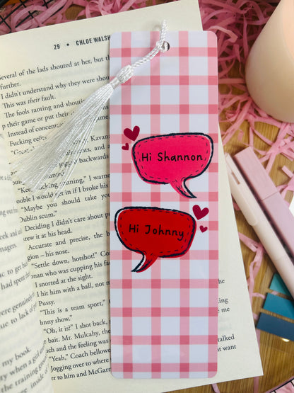 Two pink gingham checked bookmarks inspired by Binding 13 by Chloe Walsh, featuring speech bubbles saying "Hi Shannon" and "Hi Johnny," surrounded by bookish accessories and soft pink aesthetic decor.
