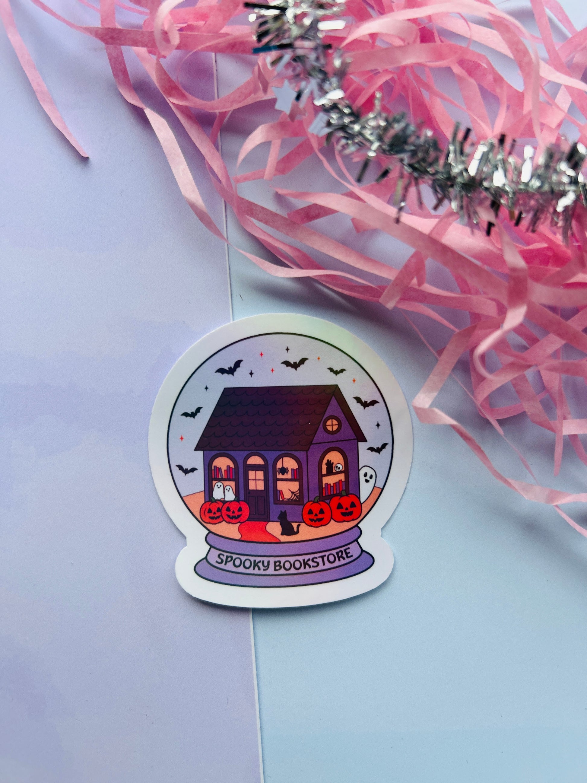 Halloween-themed sticker of a purple house with pumpkins on a light purple background.